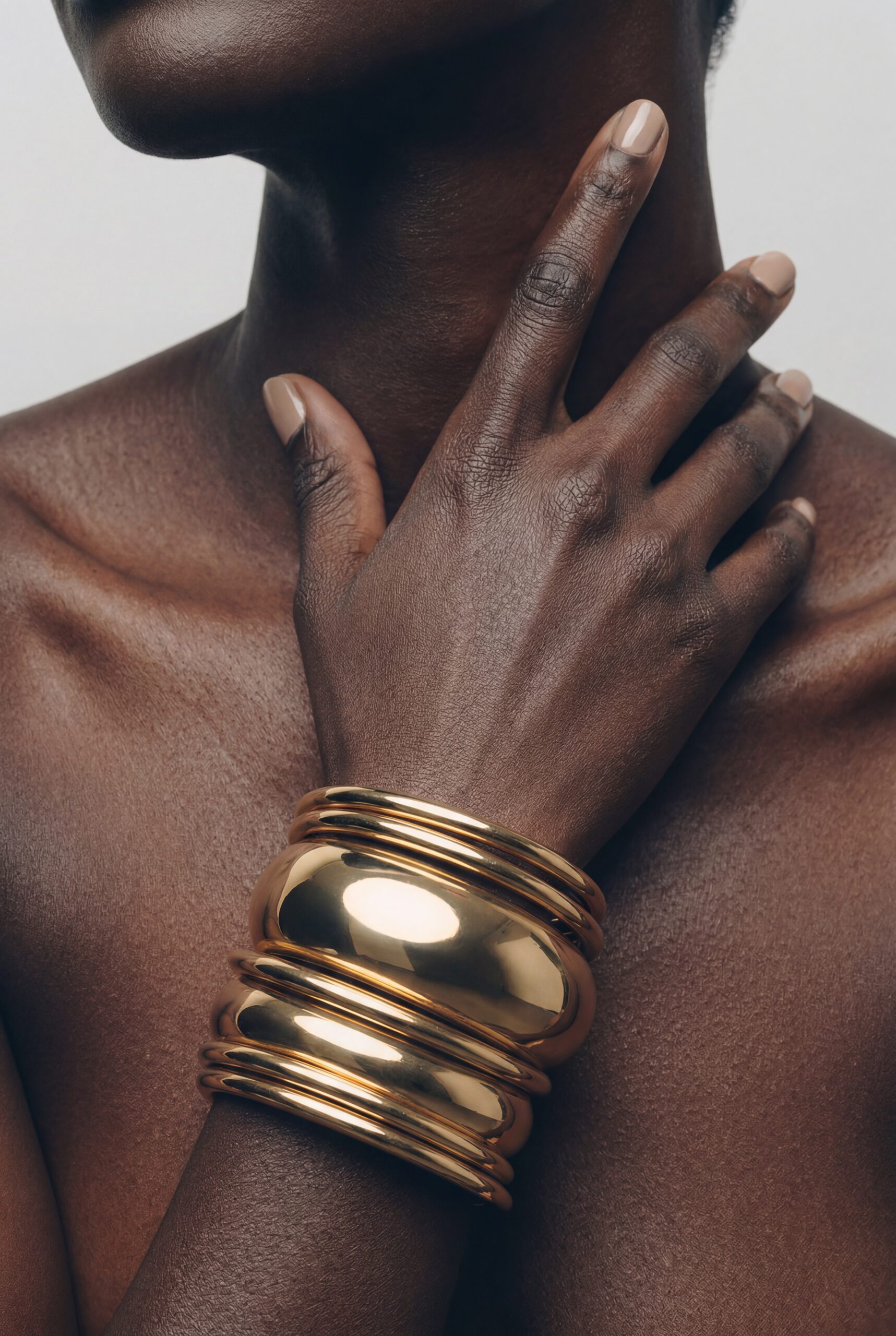 Elegant beauty styling with stacked gold bangles